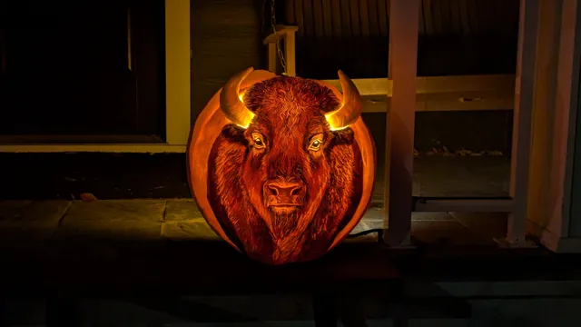 A pumpkin carved with a glowing bison head on a porch in Edmonton on Halloween 2024