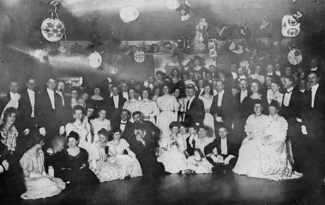 A crowd in evening dress under paper lanterns at a Halloween party in Edmonton in 1906